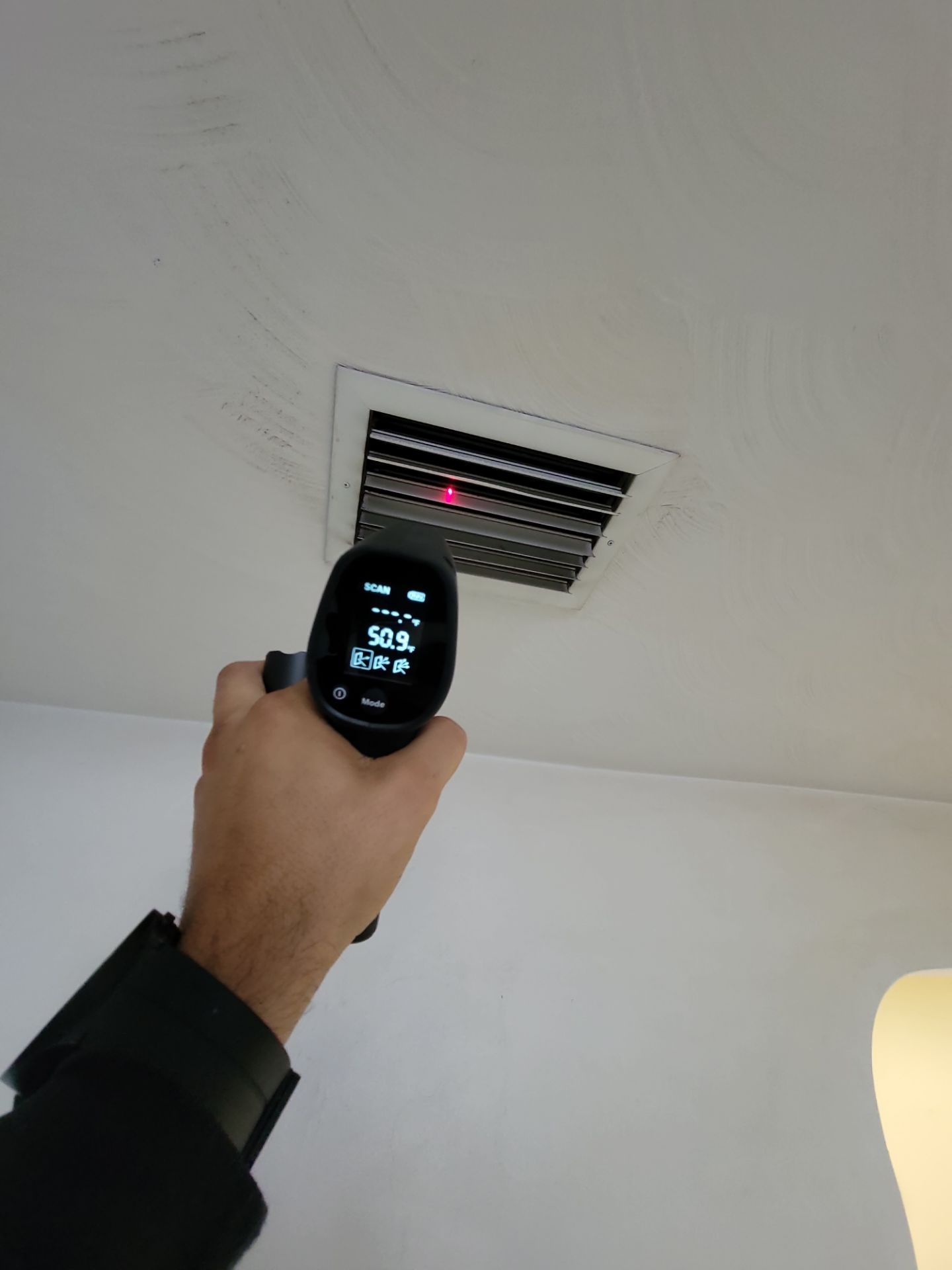 Picos Pro Inspections checking air vent temperature with an infrared thermometer
