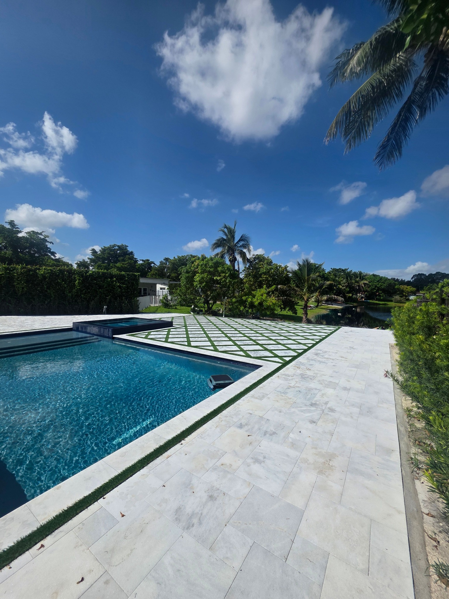Completed poolside patio with pavers and lawn accents